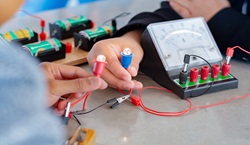 People looking at electrical circuits
